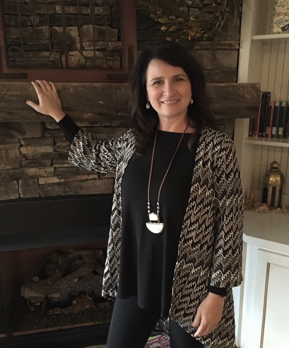 Julie Fillinger standing in front of the fireplace