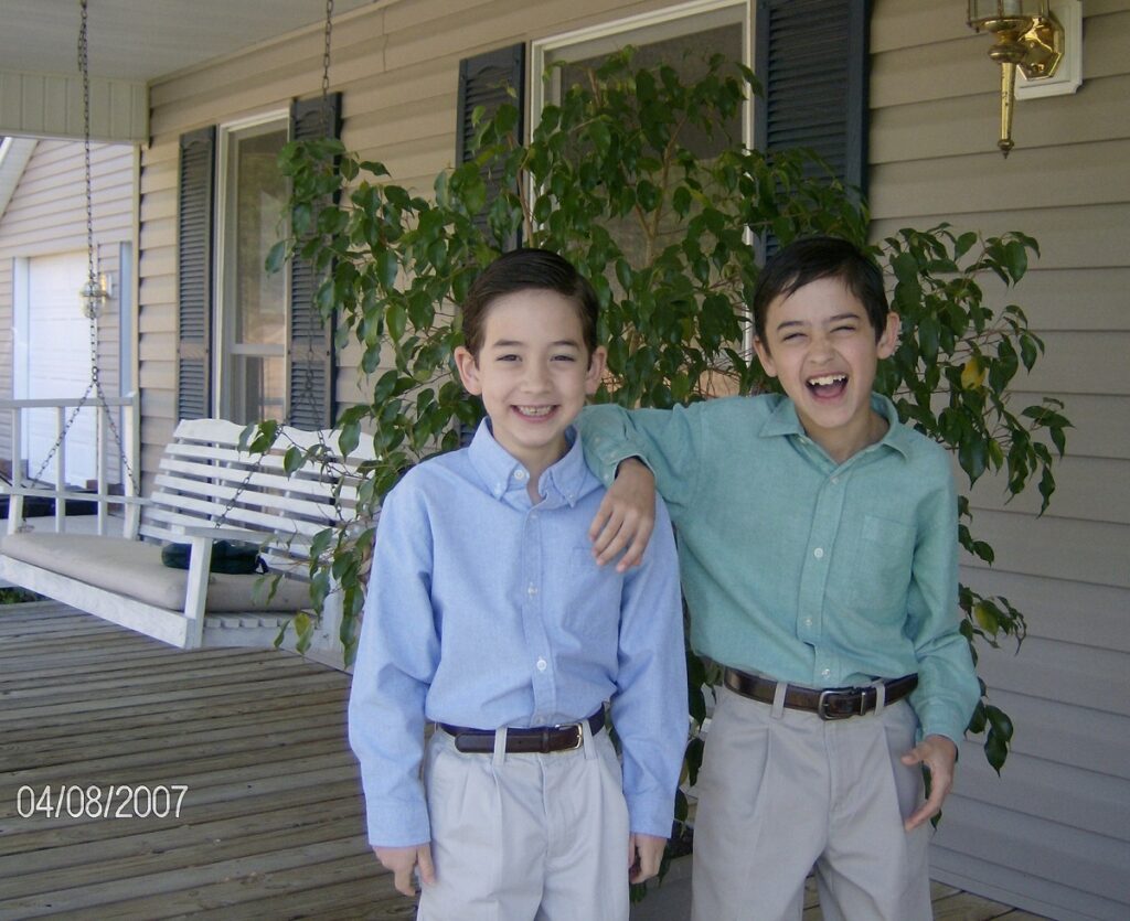 Nicholas Fillinger and Drew Fillinger. Unscripted smiles in Easter clothes on the front porch.