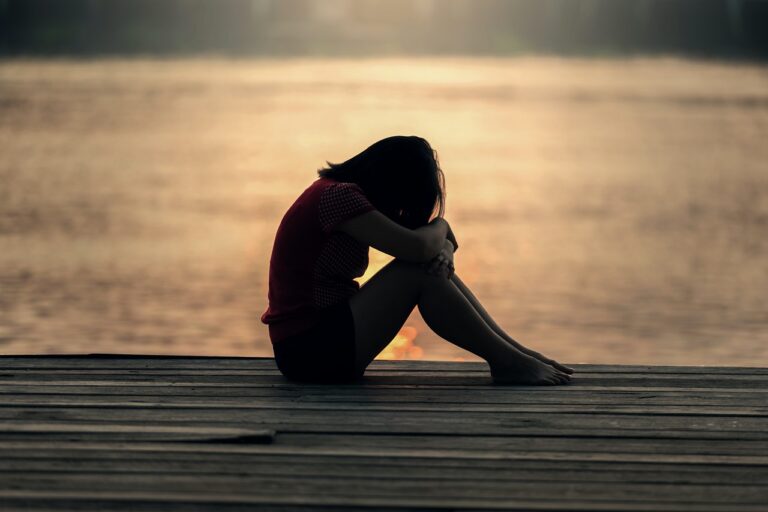 Sitting on the deck, bowing in prayer