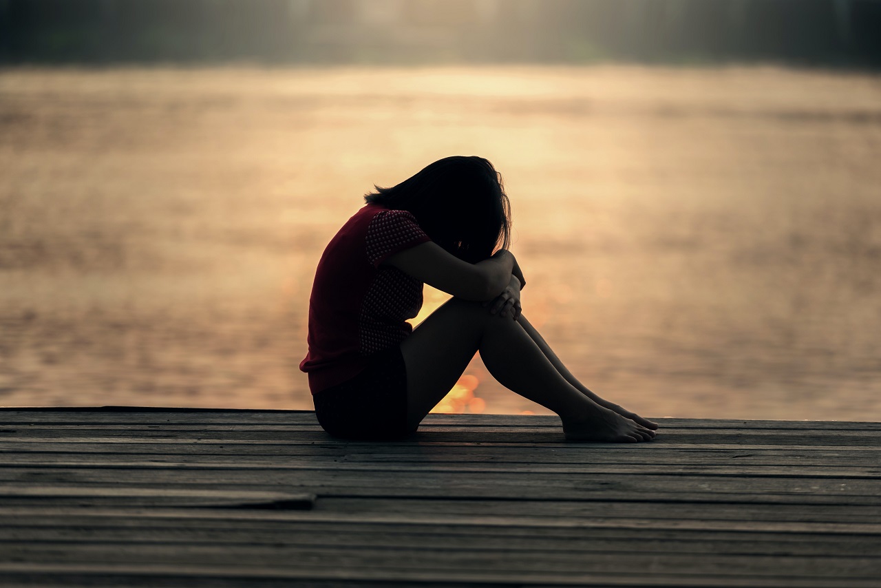 Sitting on the deck, bowing in prayer