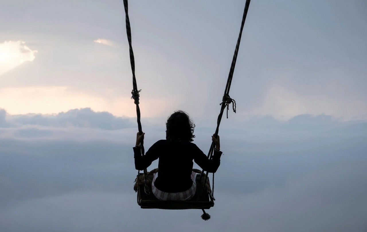 Woman swinging on a large swing